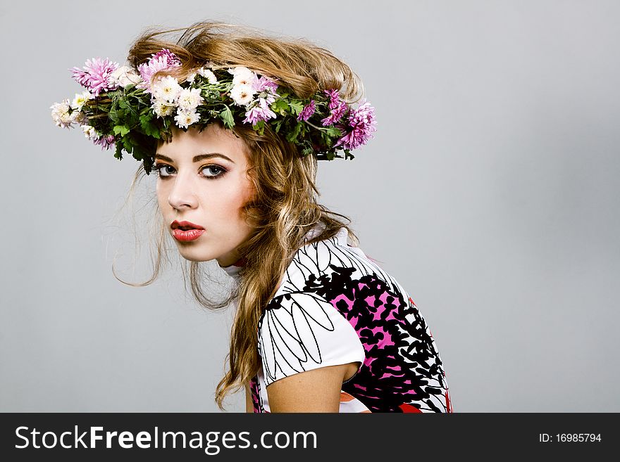 Portrait of a beautiful fashion model in flower crown. Portrait of a beautiful fashion model in flower crown