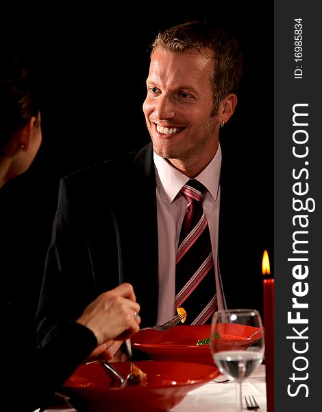Man and woman having a romantic candle light dinner