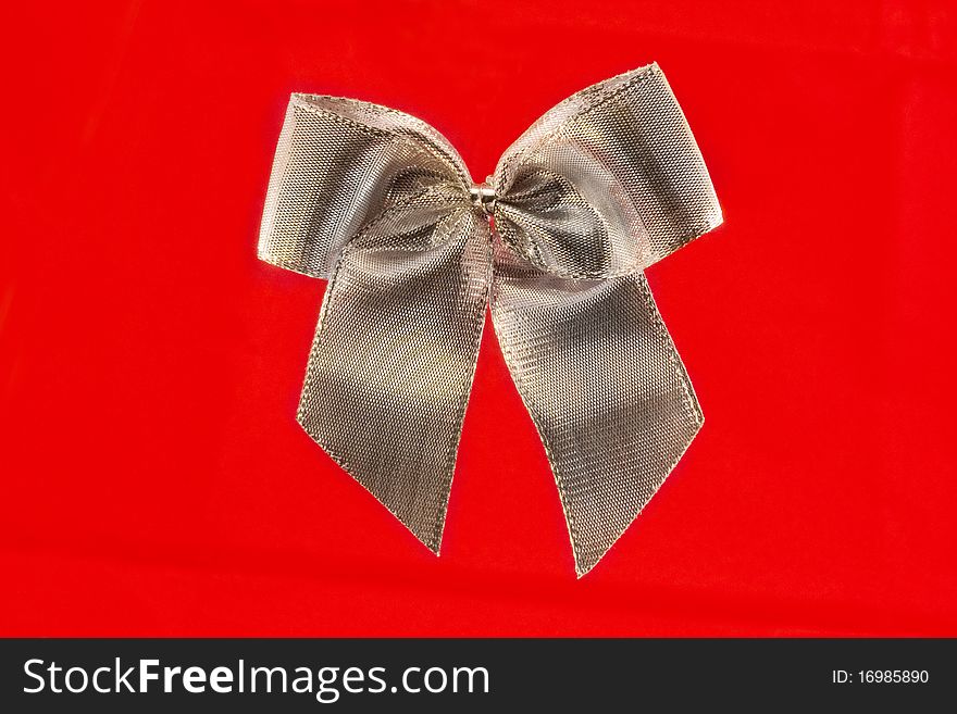 Single silver bow isolated over red