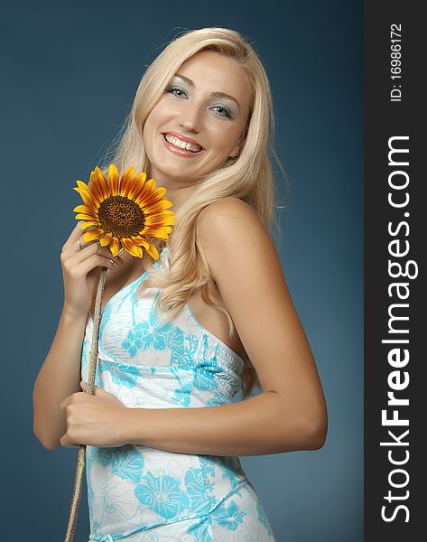 The beautiful girl with white hair on a dark blue background. The beautiful girl with white hair on a dark blue background.