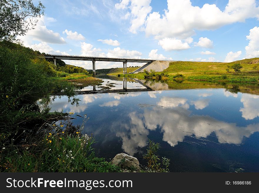 Auto-bridge across river. Nature: summer
