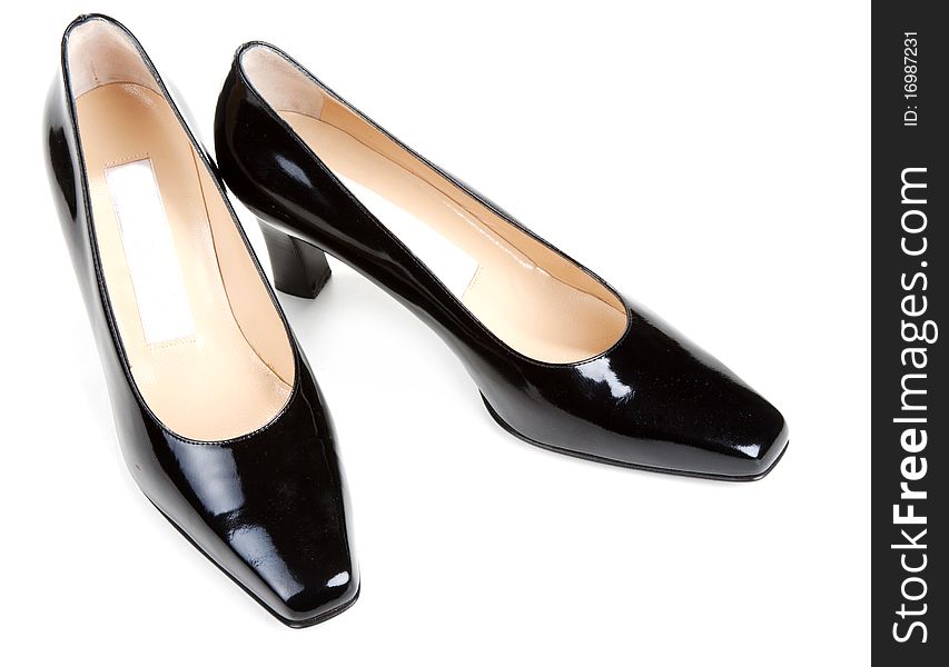 Black feminine varnished loafers on white background