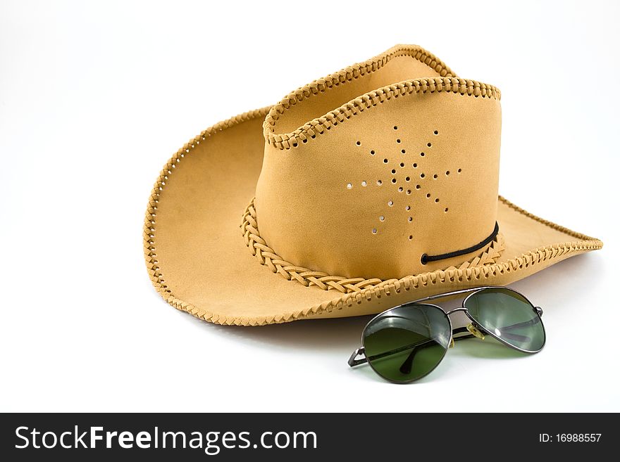 Cowboy hat and sunglasses isolated on the white background