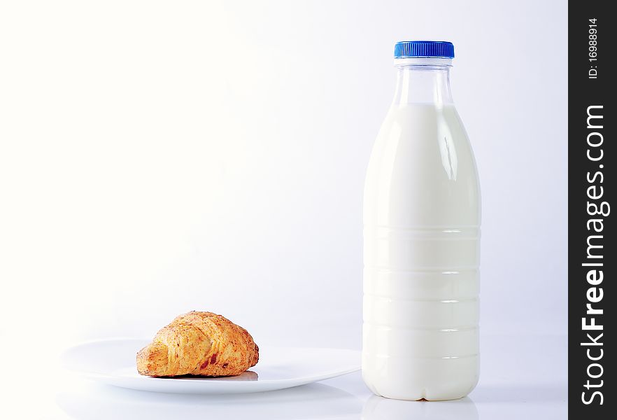 Croissants and milk on white background