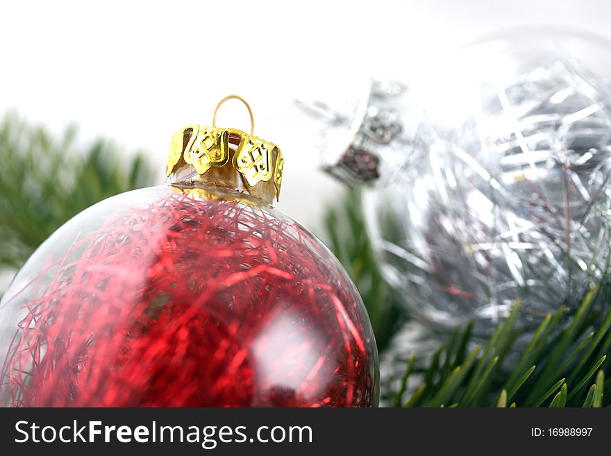 Two Christmas decoration bubbles on pine tree bunch