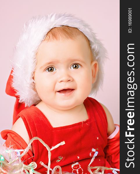 Baby in Santa Claus hat on white background