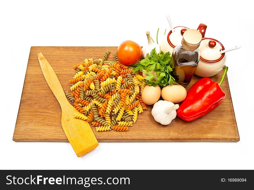 Close-up shot of pasta and vegetables on wooden board. Studio shot