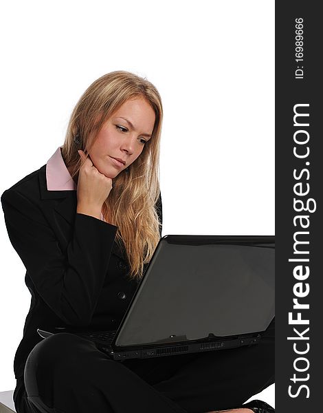 Young businesswoman with a laptop computer sitting and isolated on a white background. Young businesswoman with a laptop computer sitting and isolated on a white background