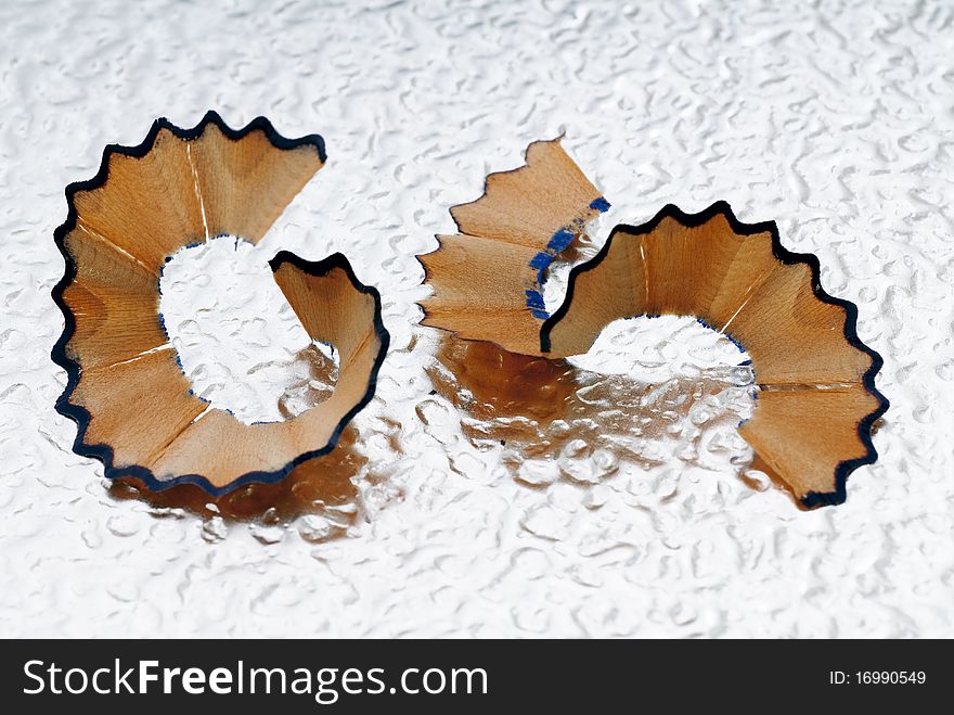 Pencil shavings on the bottom of corrugated metal