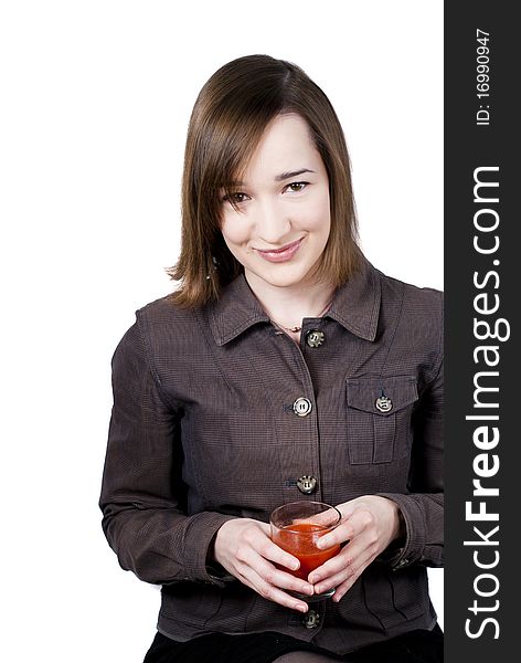 Smiling girl holding the glass of tomato juice isolated