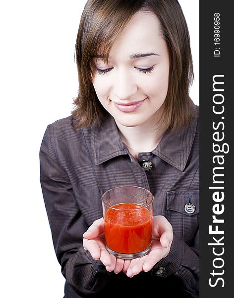 Smiling girl holding the glass of tomato juice isolated