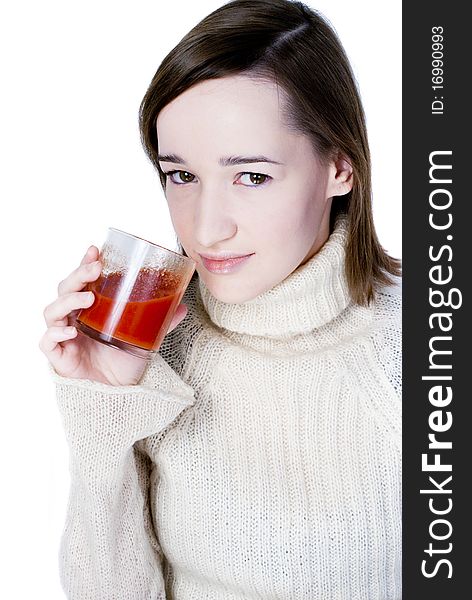 Girl drinking the glass of tomato juice isolated