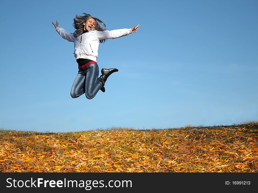 Funny young girl jumping and smile outdoors. Funny young girl jumping and smile outdoors