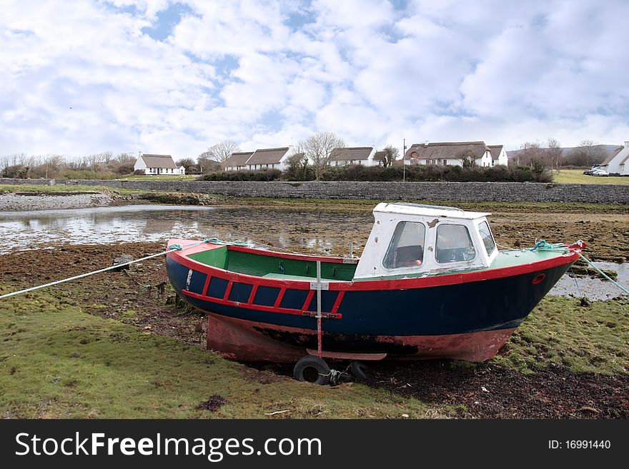 An old boat in a bay in ireland. An old boat in a bay in ireland