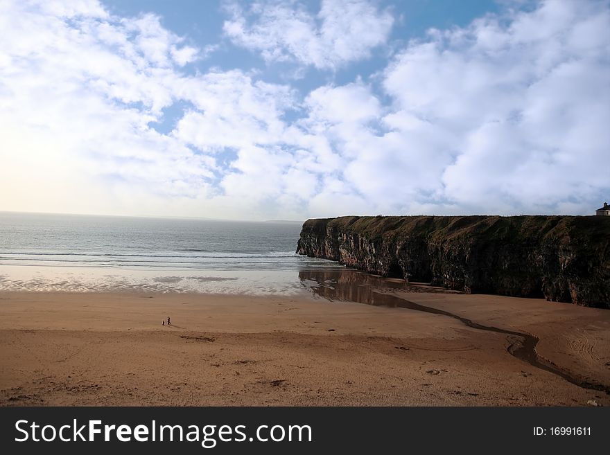 A view of the beach cliffs in ballybunion co kerry ireland with walkers. A view of the beach cliffs in ballybunion co kerry ireland with walkers