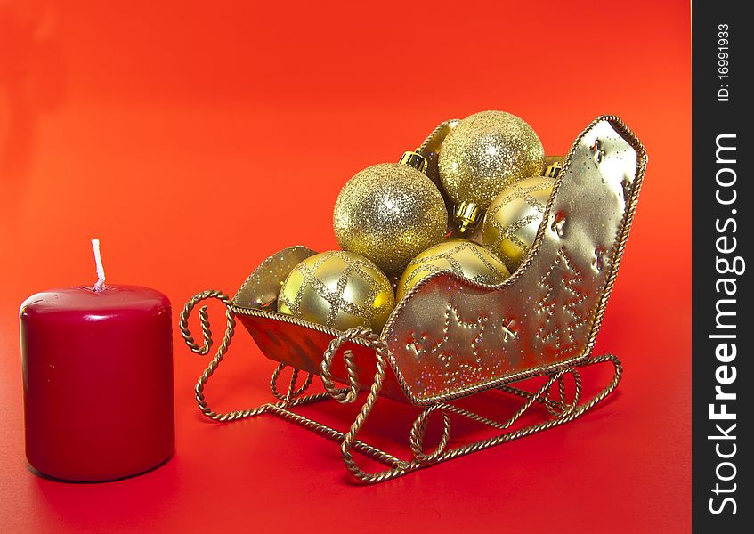 Christmas sledge withe christmas ball isolated on red. Christmas sledge withe christmas ball isolated on red