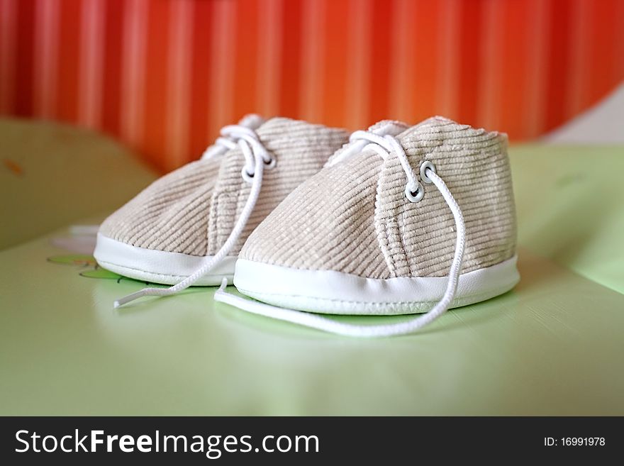 Baby shoes on a colored background