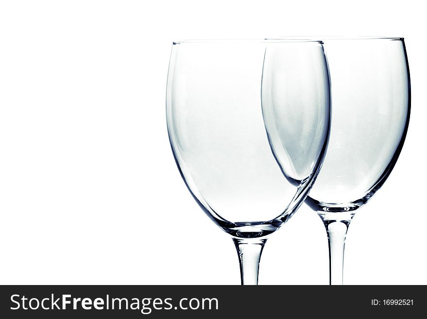 Two glasses one behind another on white background. Two glasses one behind another on white background