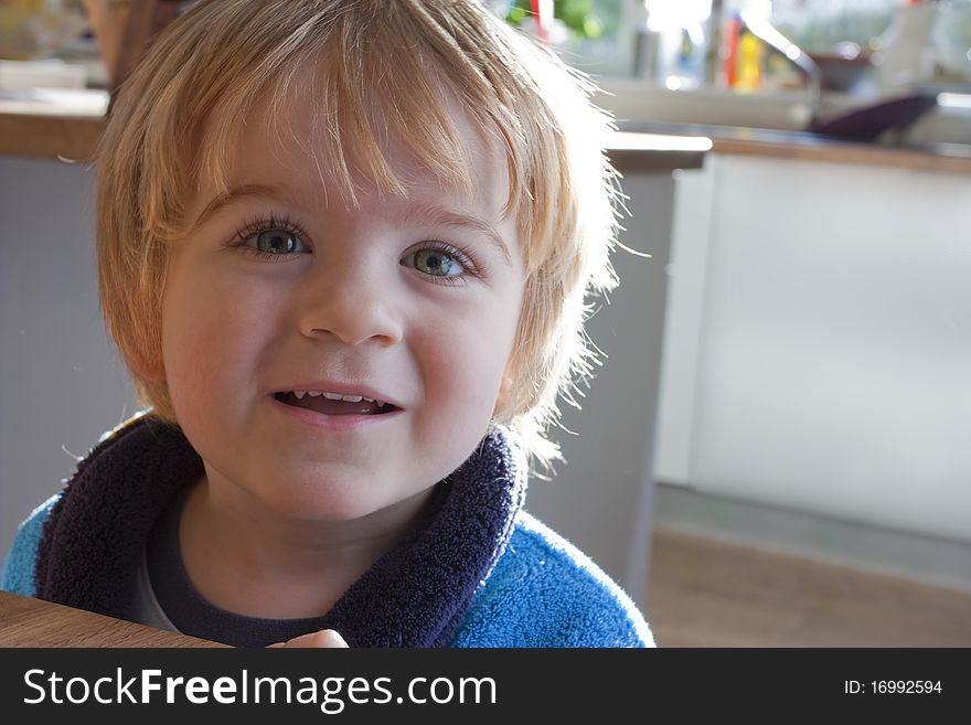 Close up of little boy smiling in the kitchen. Close up of little boy smiling in the kitchen