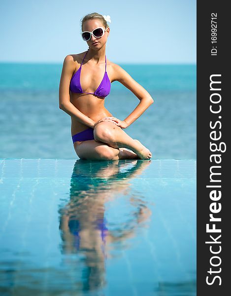 Beautiful young woman relaxing in the pool. Beautiful young woman relaxing in the pool