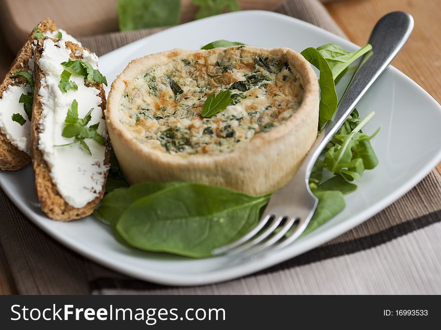 Freshly made spinach quiche with watercress and toast