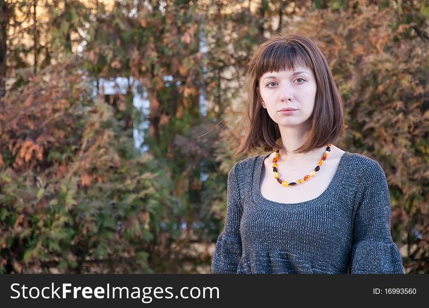 Portrait of a girl on a background of autumn leaves