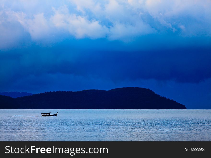 Thunder storm with rain lit by the sun at a lake