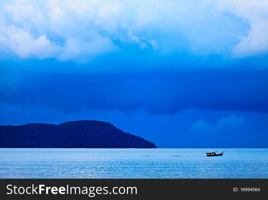 Thunder storm with rain lit by the sun at a lake