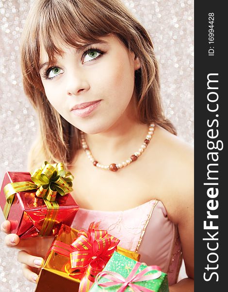 Dreamy beautiful girl holds the holiday gifts