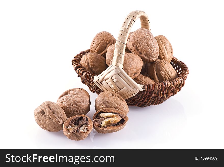 Walnuts in basket isolated on a white background. Walnuts in basket isolated on a white background.