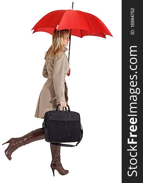 Businesswoman with her raincoat and umbrella going to work. Businesswoman with her raincoat and umbrella going to work