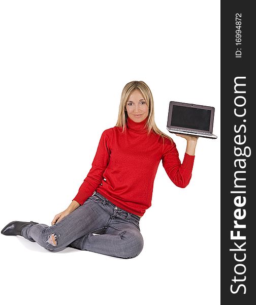 Happy working woman sitting on the floor with her laptop