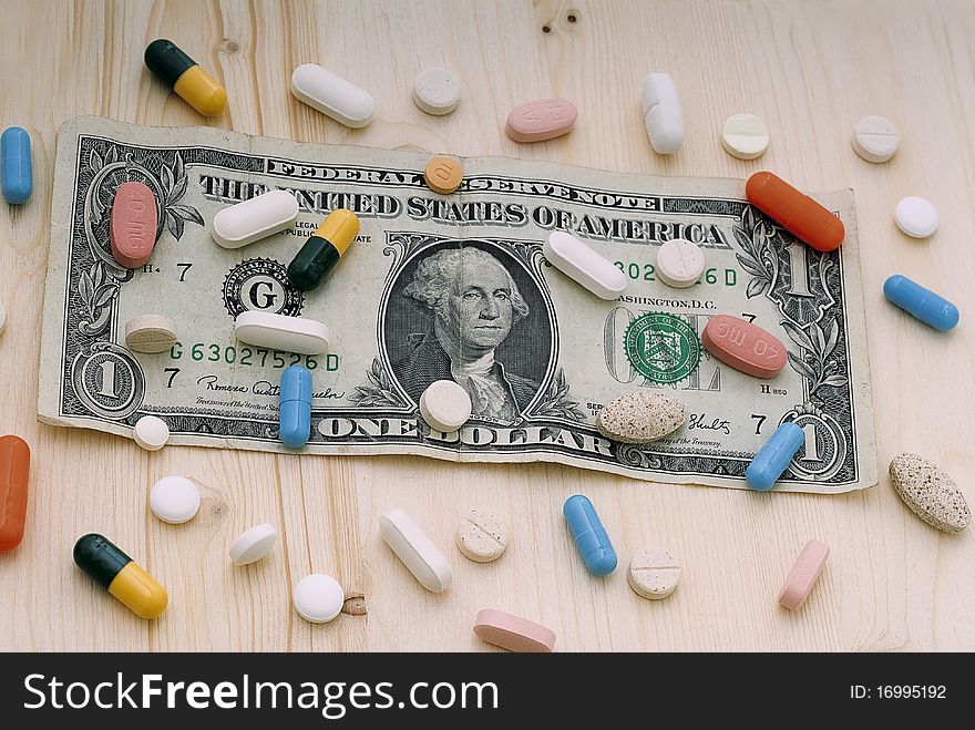 Colored pills on a dollar bill. Colored pills on a dollar bill