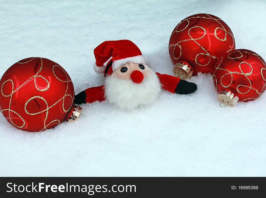 Red Christmas balls, and Nicholas in the snow