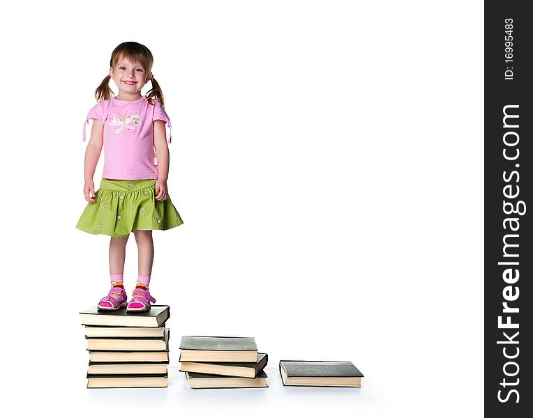 Sad little girlsit near a stack of big books on white background. Sad little girlsit near a stack of big books on white background