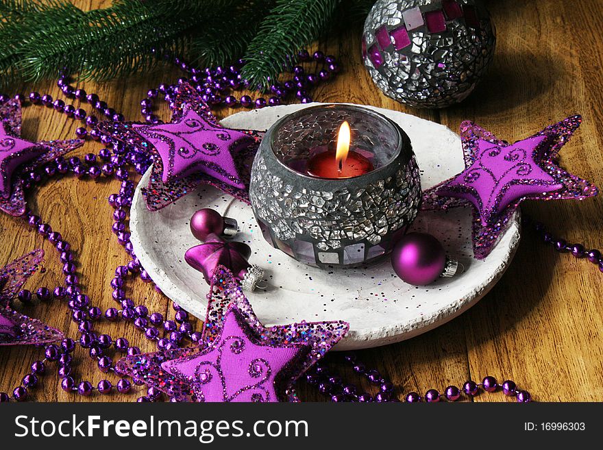 Christmas table with candles and purple christmas decoration. Christmas table with candles and purple christmas decoration