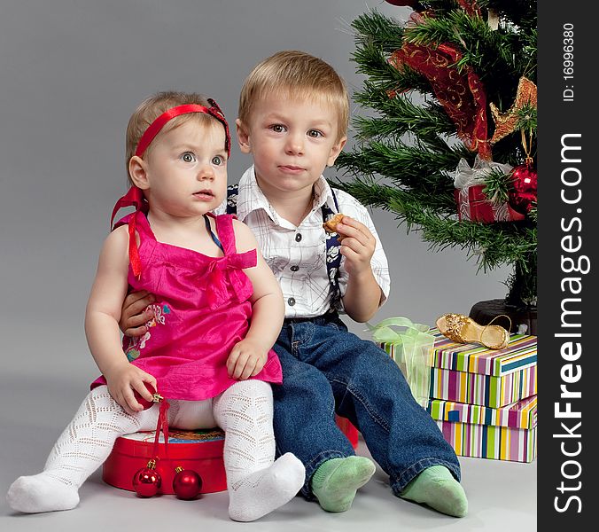 Brother and sister with their presents at christmas time