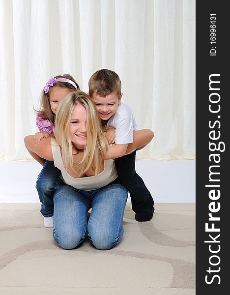 A young mother, her daughter and son having fun together