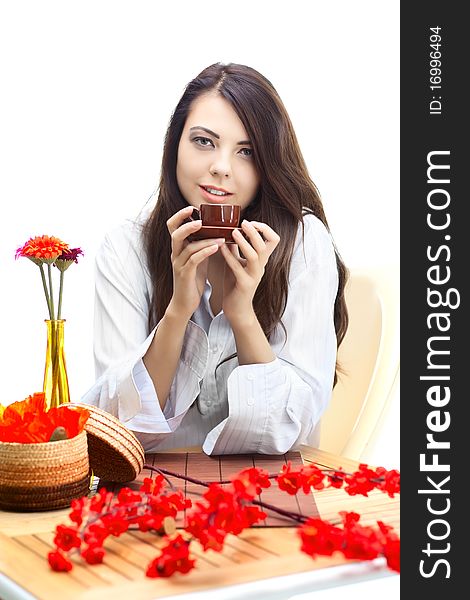 Beautiful woman in cafe over white background with red flowers. Beautiful woman in cafe over white background with red flowers