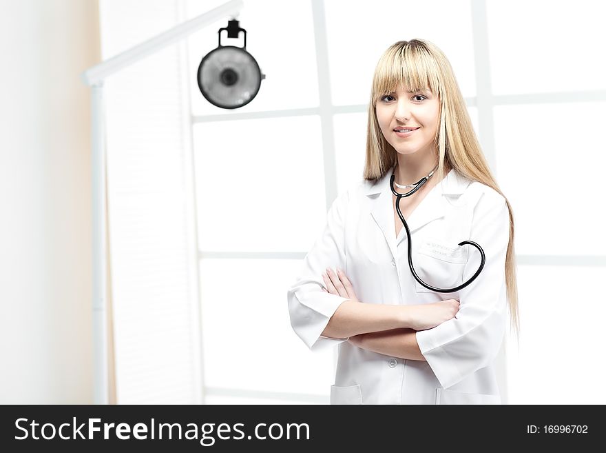 Woman doctor with blond hair in white. Woman doctor with blond hair in white
