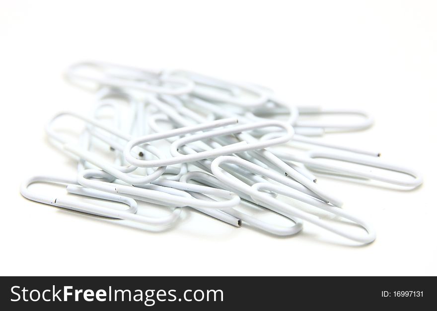 Color paper clips to background. Isolated on white background