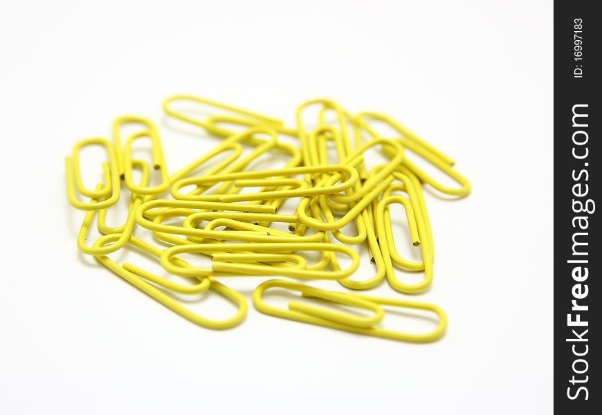 Color paper clips to background. Isolated on white background
