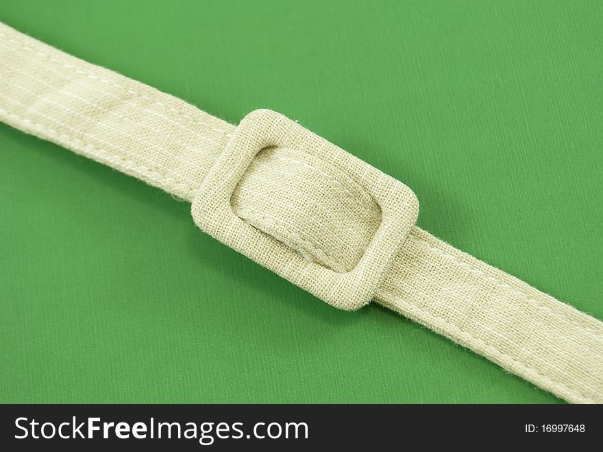 Women's belt on top of a green background