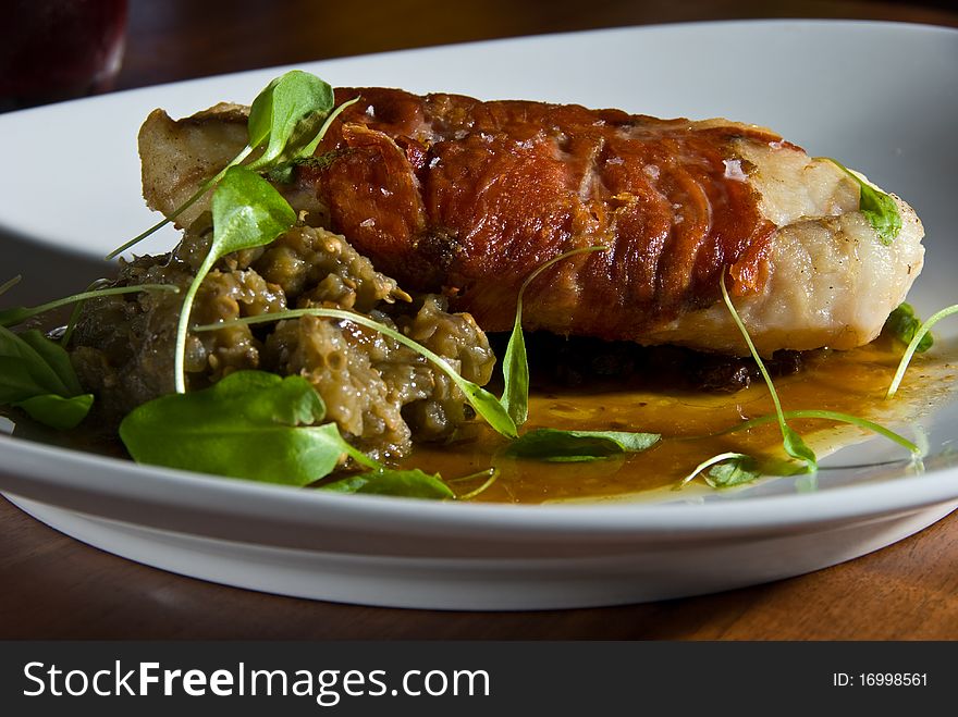 Bacon wrapped fish with greens