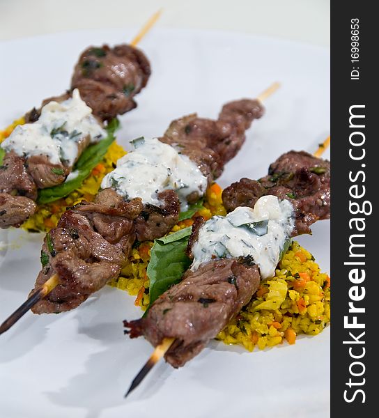 Beef Skewers Over Yellow Rice