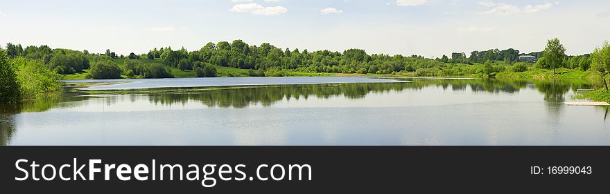 Panorama of a summer landscape with the river and wood. Sheksna, Vologda region (Russia)