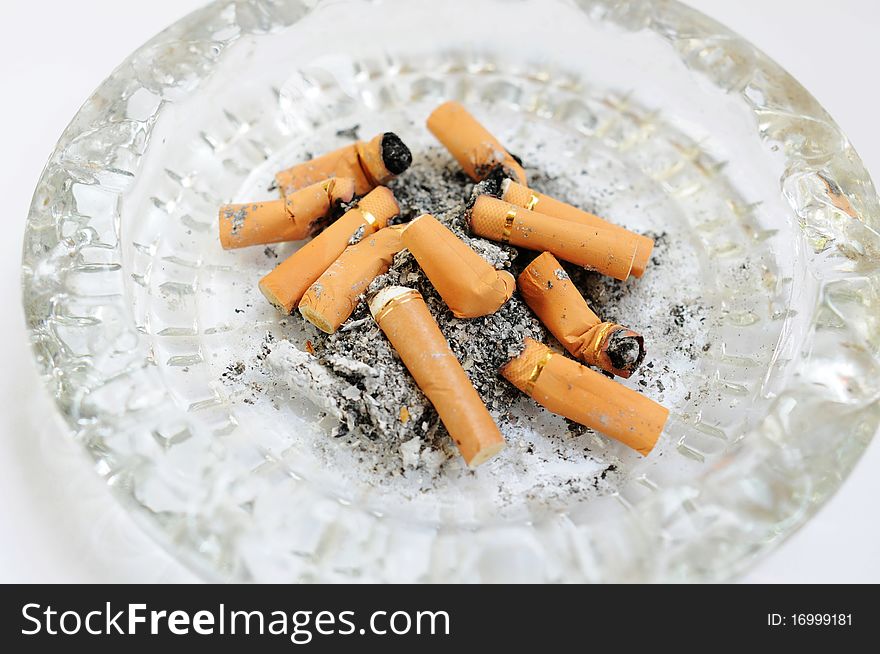 Close view of an ashtray filled with cigarette butts. Close view of an ashtray filled with cigarette butts.