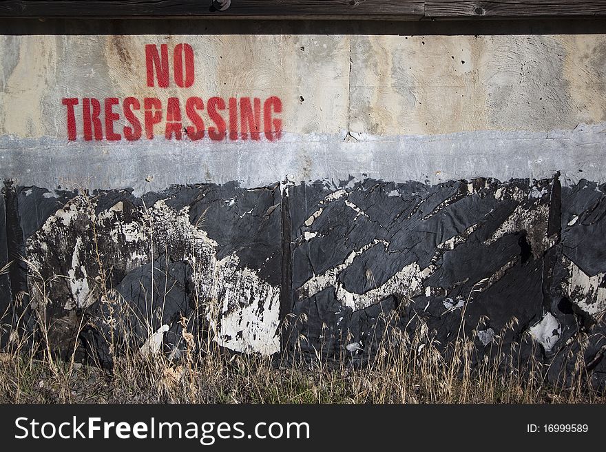 Spray painted no trespassing cement. Spray painted no trespassing cement