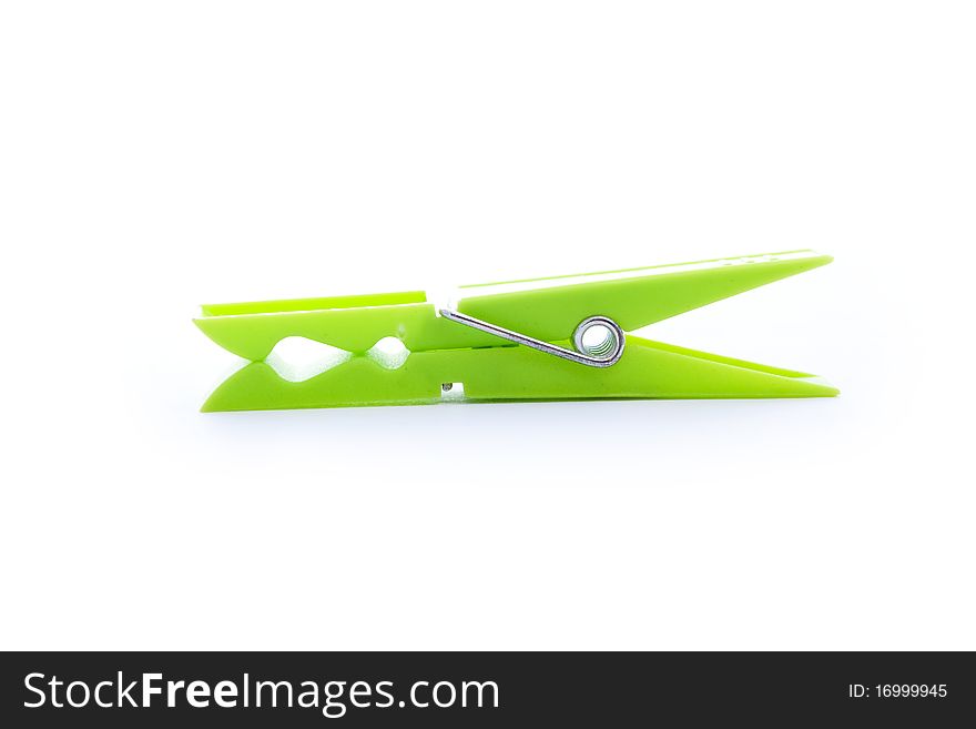 Close up shot of green clothespin isolated on white