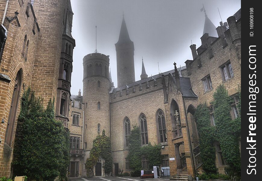 Mystic castle in the fog which looks like Hogwarts